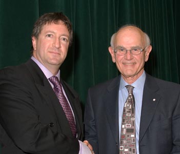 Charles Tator (right) presents the Charles Tator Surgeon-Scientist Mentoring Award to Joel Fish (PlasSurg)