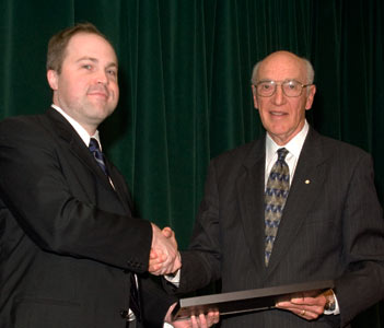 Bernard Langer (right) presents the Bernard Langer Surgeon Scientist Award to Michael Taylor (NeurSurg)